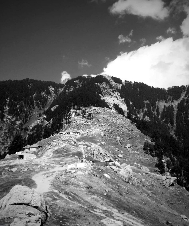 Rocky mountain terrain with small settlement and pine forests